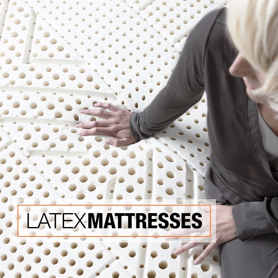 Hand pressing into the latex mattress to show elasticity